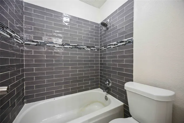 a bathroom with a toilet and bathtub