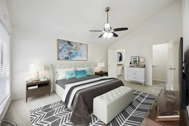 a bedroom with bed and a chandelier