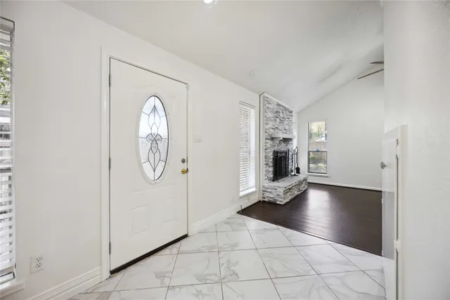 a view of a livingroom with wooden floor and a fireplace