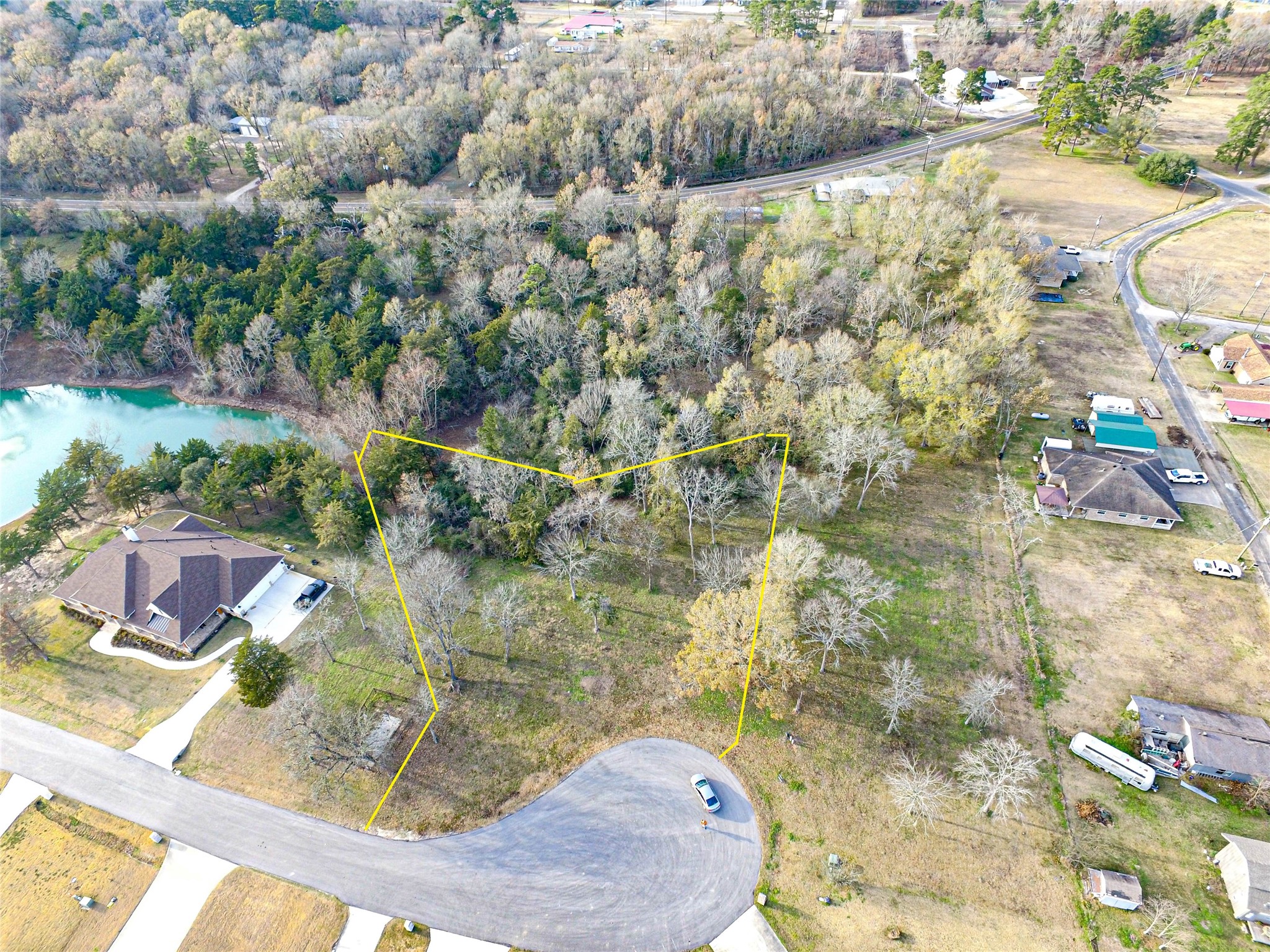 131 Legacy Boulevard Point Blank, TX 77364 - Photo 2 of 17 The yellow outlined area is an approximate boundary line for this almost acre lot. Note the pond located in the back left allows access to the pond.