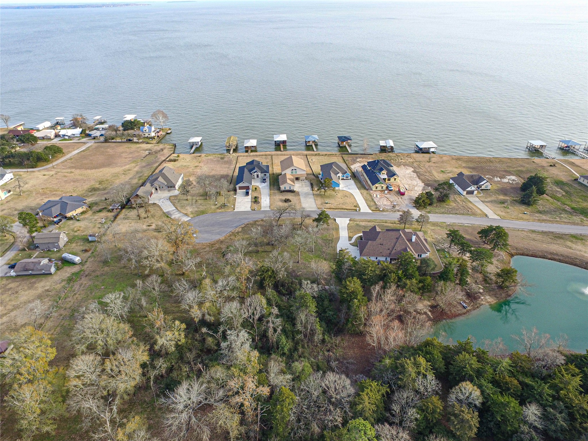 131 Legacy Boulevard Point Blank, TX 77364 - Photo 9 of 17 Closer arial view of small creek bed and how this lot accesses the pond for access.