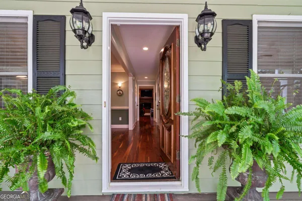 a dining room with furniture a chandelier and window