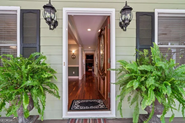 a dining room with furniture a chandelier and window