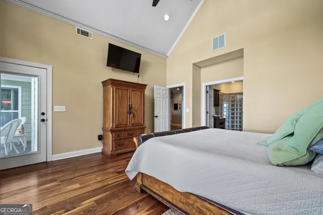 a bedroom with a bed and a painting on the wall