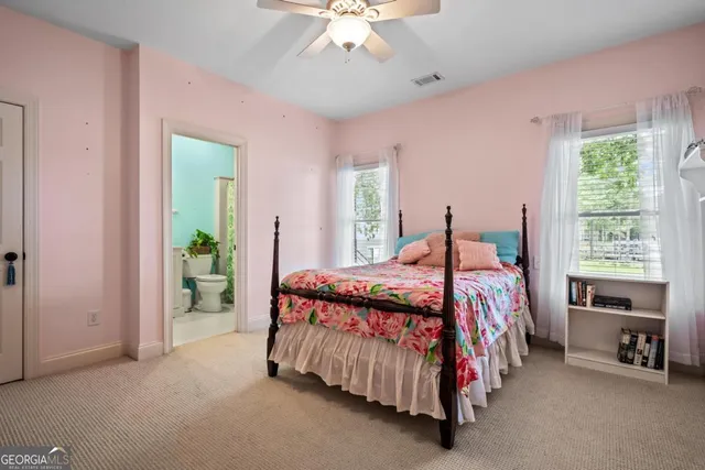 a bedroom with a bed and a lamp on table