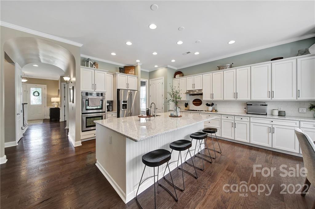 1429 Secret Path Drive Fort Mill, SC 29708 - Photo 15 of 42 a kitchen with white cabinets and stainless steel appliances