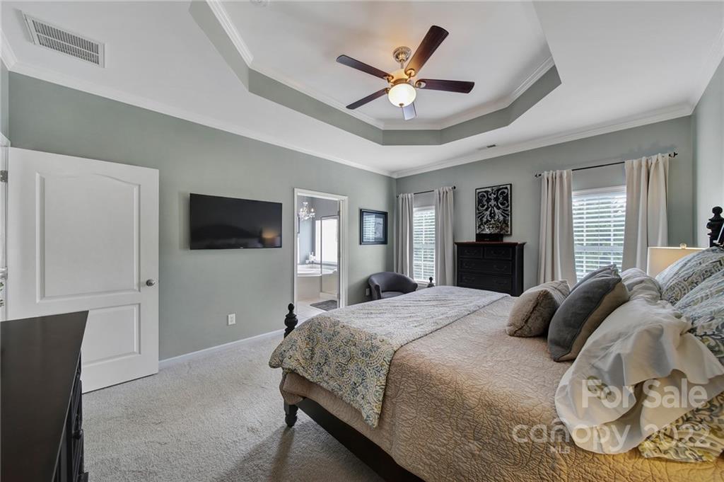 1429 Secret Path Drive Fort Mill, SC 29708 - Photo 22 of 42 a bedroom with a bed and a flat screen tv