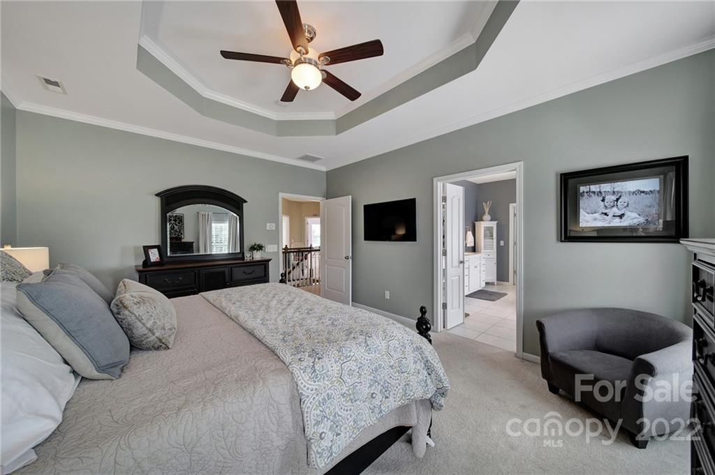 1429 Secret Path Drive Fort Mill, SC 29708 - Photo 23 of 42 a bedroom with a bed a mirror on desk and a chair