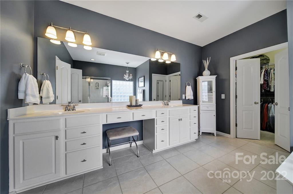 1429 Secret Path Drive Fort Mill, SC 29708 - Photo 24 of 42 a spacious bathroom with a double vanity sink and a mirror