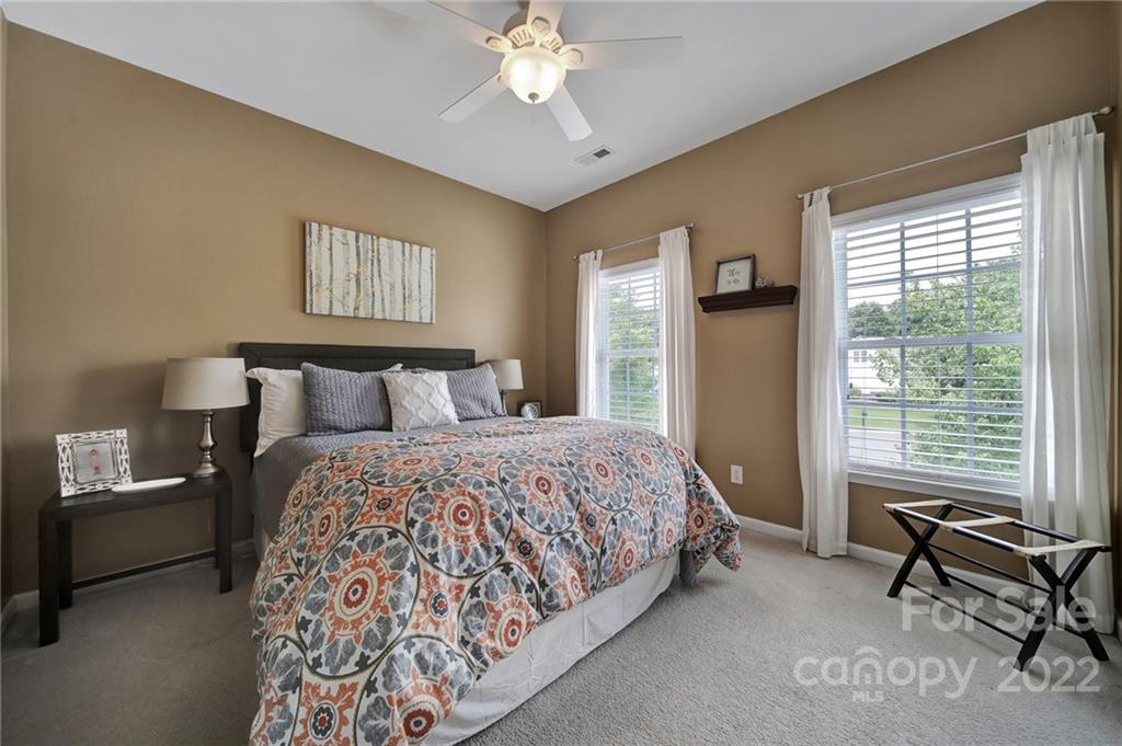 1429 Secret Path Drive Fort Mill, SC 29708 - Photo 26 of 42 a bedroom with a bed and a chandelier
