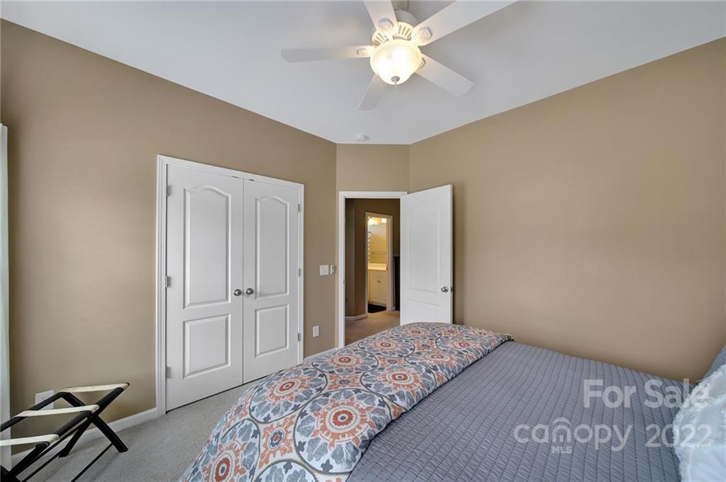 1429 Secret Path Drive Fort Mill, SC 29708 - Photo 27 of 42 a bedroom with a bed and a chandelier