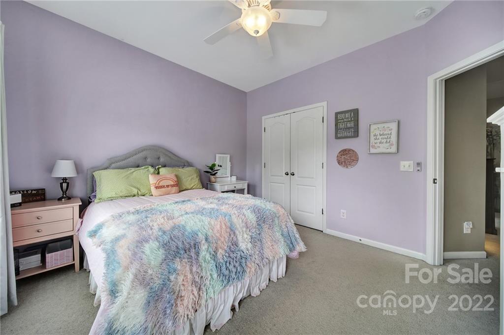 1429 Secret Path Drive Fort Mill, SC 29708 - Photo 29 of 42 a bedroom with a bed and a chandelier