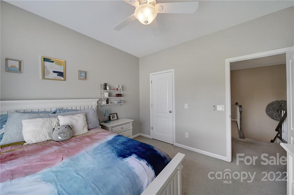 1429 Secret Path Drive Fort Mill, SC 29708 - Photo 30 of 42 a bedroom with a bed and a chandelier