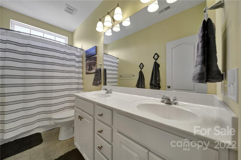 1429 Secret Path Drive Fort Mill, SC 29708 - Photo 31 of 42 a bathroom with a sink vanity and a mirror