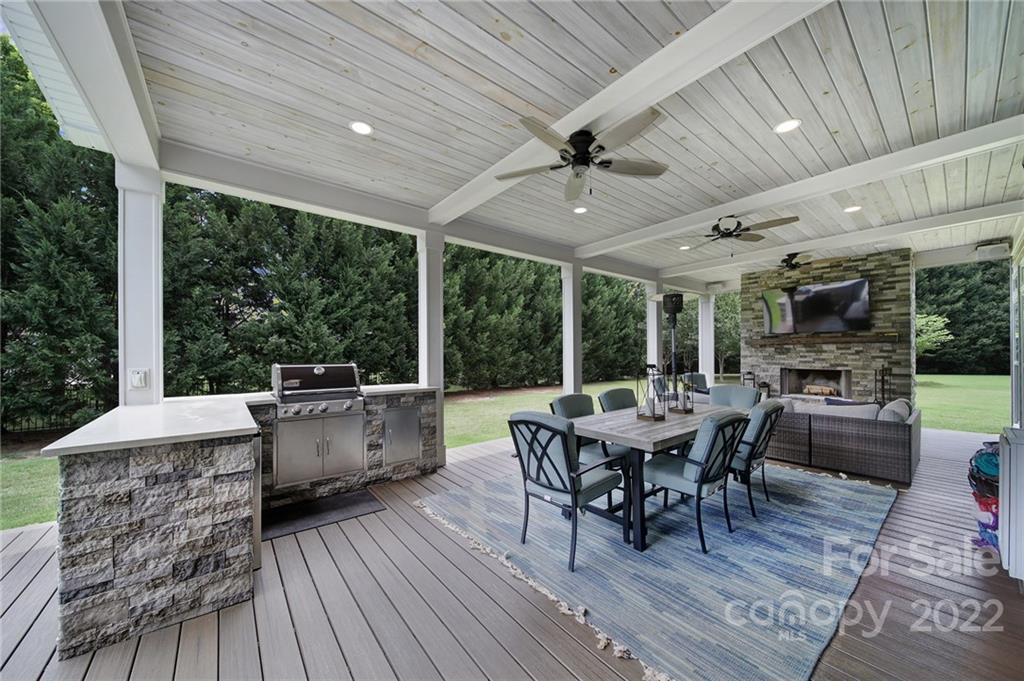 1429 Secret Path Drive Fort Mill, SC 29708 - Photo 36 of 42 a view of a patio with table and chairs barbeque with wooden floor and fence