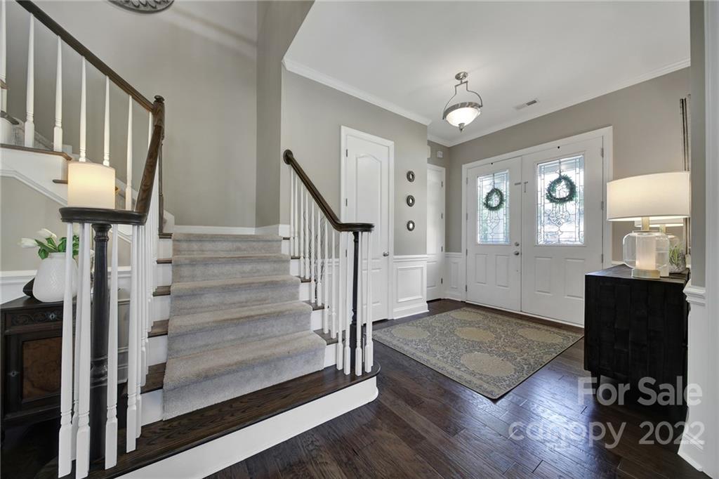 1429 Secret Path Drive Fort Mill, SC 29708 - Photo 4 of 42 a view of a hallway with wooden floor and staircase