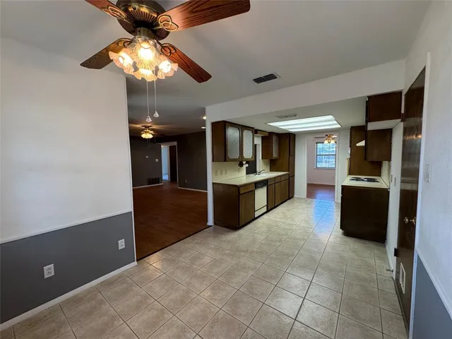 a large kitchen with cabinets and stainless steel appliances