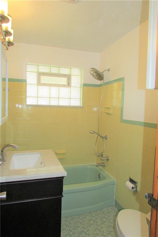 668 Kelso Road Mt. Lebanon, PA 15243 - Photo 12 of 25 Main bath with beautiful vintage yellow & green ceramic tile, new vanity with granite top, new medicine cabinet, lighting and rain shower head.