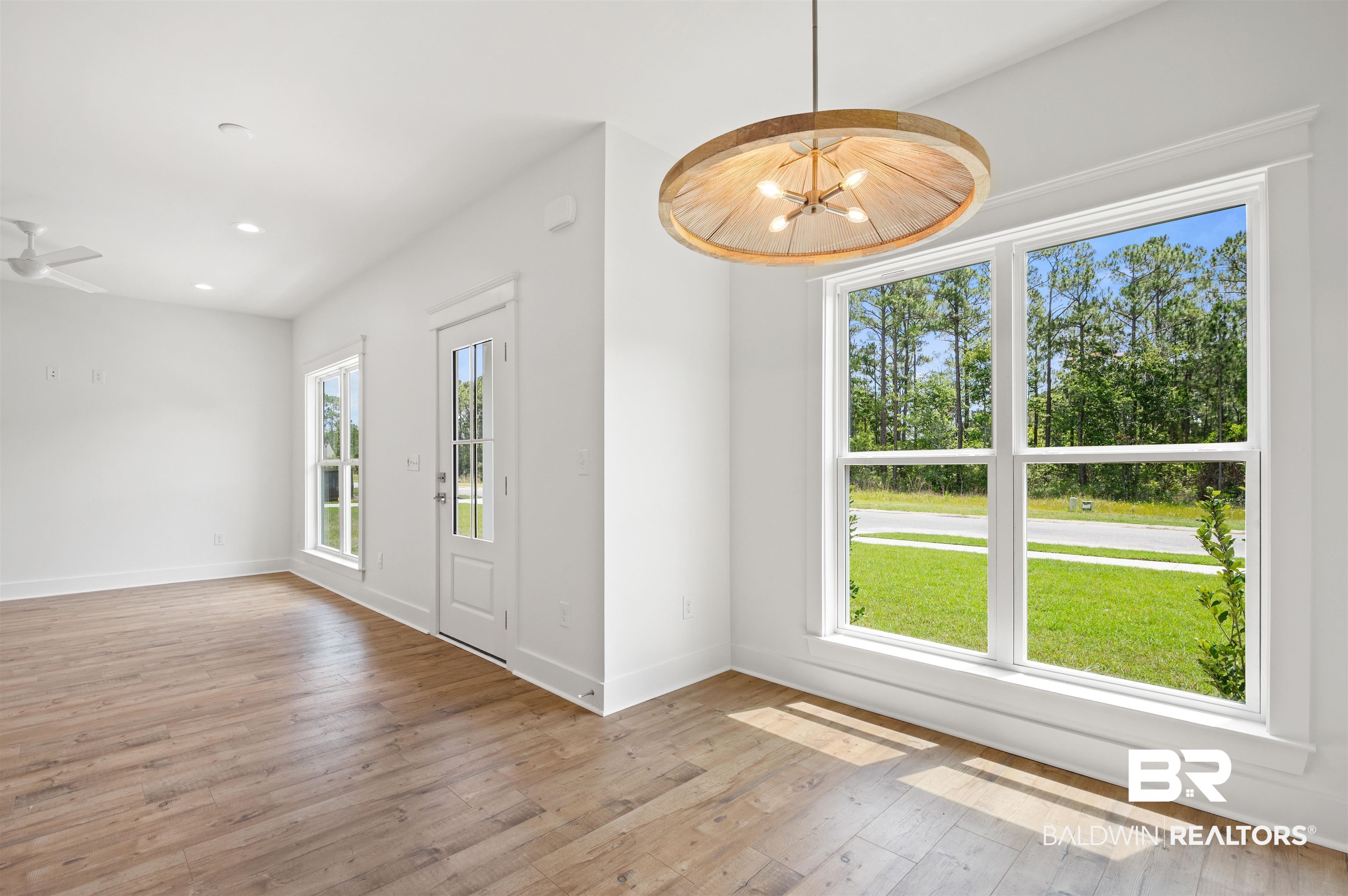 657 Island Way Gulf Shores, AL 36542 - Photo 12 of 59 Spare room with hardwood / wood-style floors, baseboards, recessed lighting, and a chandelier