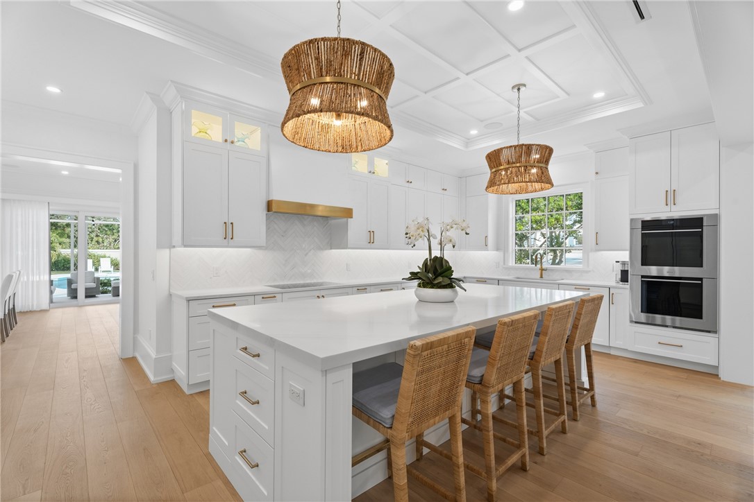 1070 Beach Road, Unit 1070 Vero Beach, FL 32963 - Photo 12 of 36 a kitchen with stainless steel appliances a dining table chairs and wooden floor