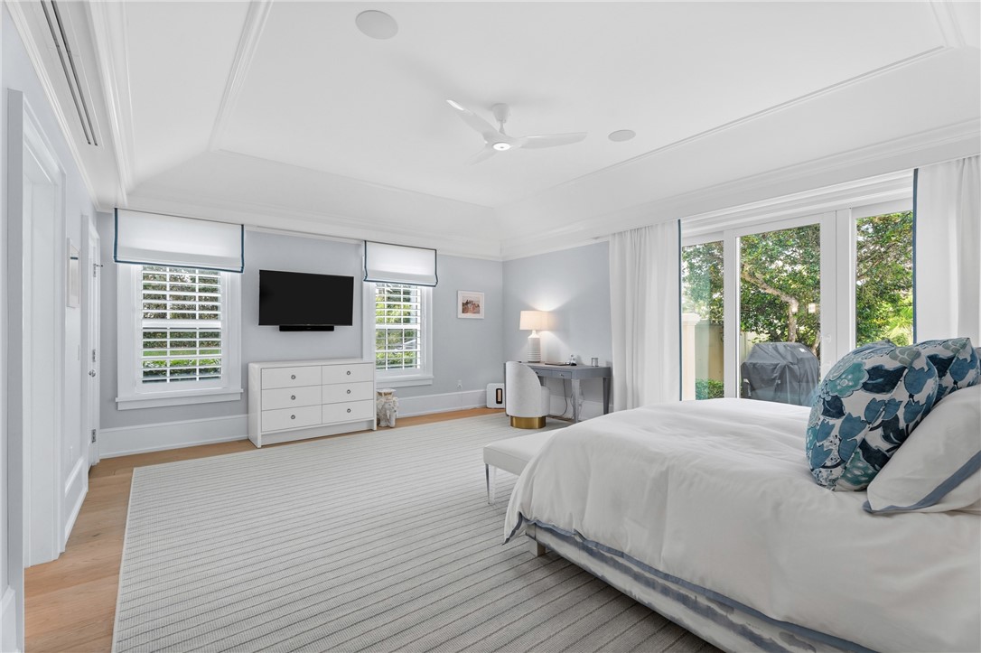 1070 Beach Road, Unit 1070 Vero Beach, FL 32963 - Photo 20 of 36 a large bedroom with a bed and a flat screen tv