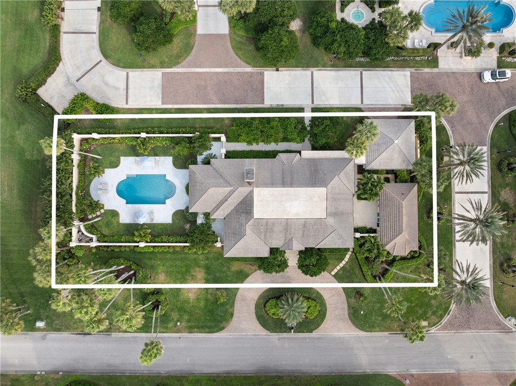 1070 Beach Road, Unit 1070 Vero Beach, FL 32963 - Photo 2 of 36 an aerial view of a house with yard swimming pool and outdoor seating