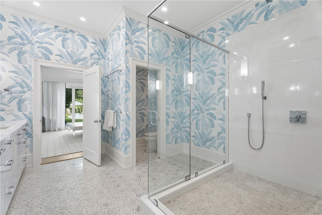 1070 Beach Road, Unit 1070 Vero Beach, FL 32963 - Photo 22 of 36 a bathroom with a glass shower door and a sink