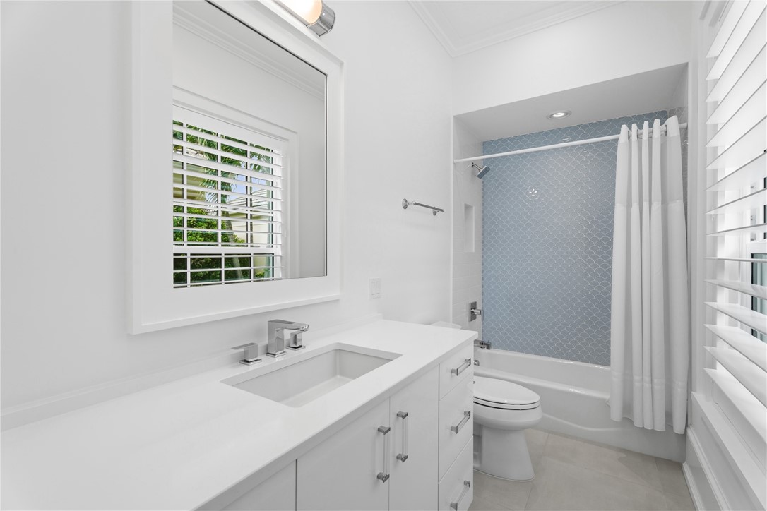 1070 Beach Road, Unit 1070 Vero Beach, FL 32963 - Photo 24 of 36 a bathroom with a sink toilet vanity and next to a window