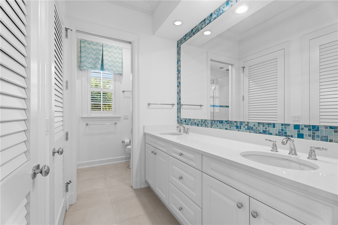 1070 Beach Road, Unit 1070 Vero Beach, FL 32963 - Photo 32 of 36 a bathroom with a sink and a mirror with bathtub