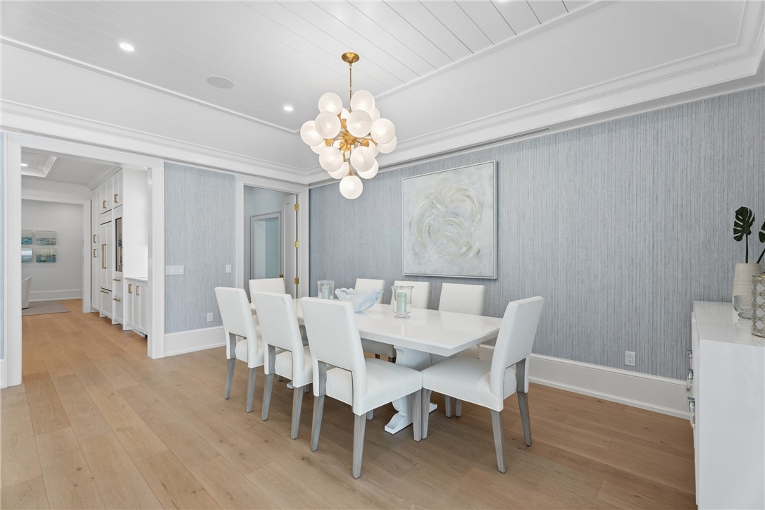 1070 Beach Road, Unit 1070 Vero Beach, FL 32963 - Photo 6 of 36 a view of a dining room with furniture wooden floor and chandelier