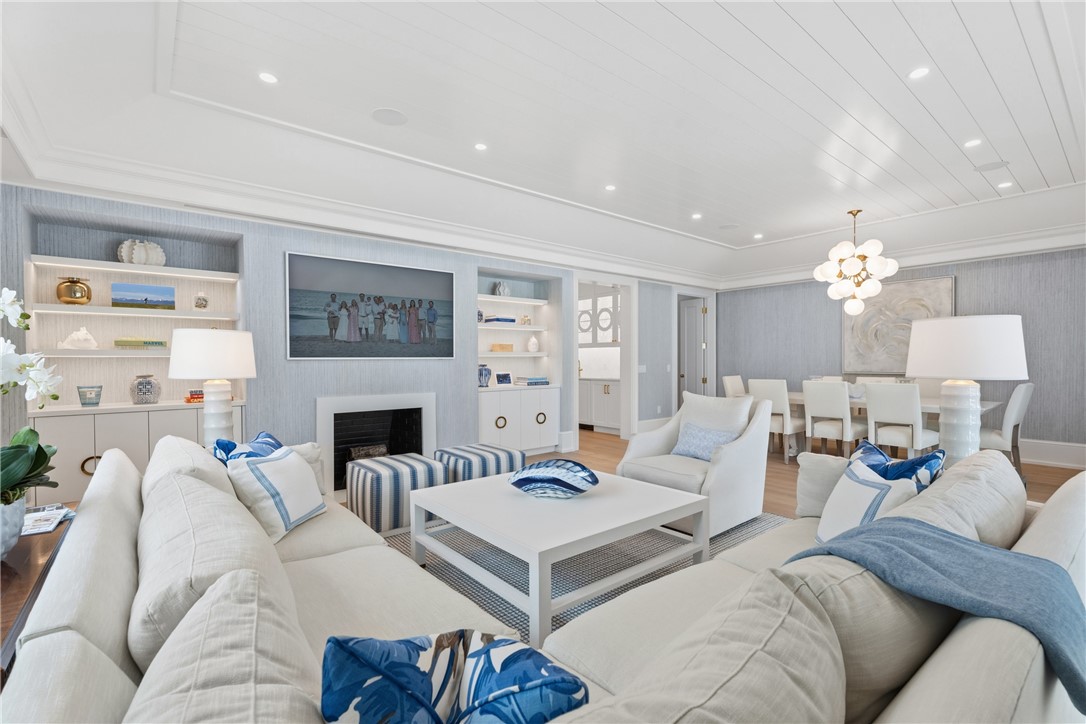 1070 Beach Road, Unit 1070 Vero Beach, FL 32963 - Photo 8 of 36 a living room with furniture a fireplace and a chandelier