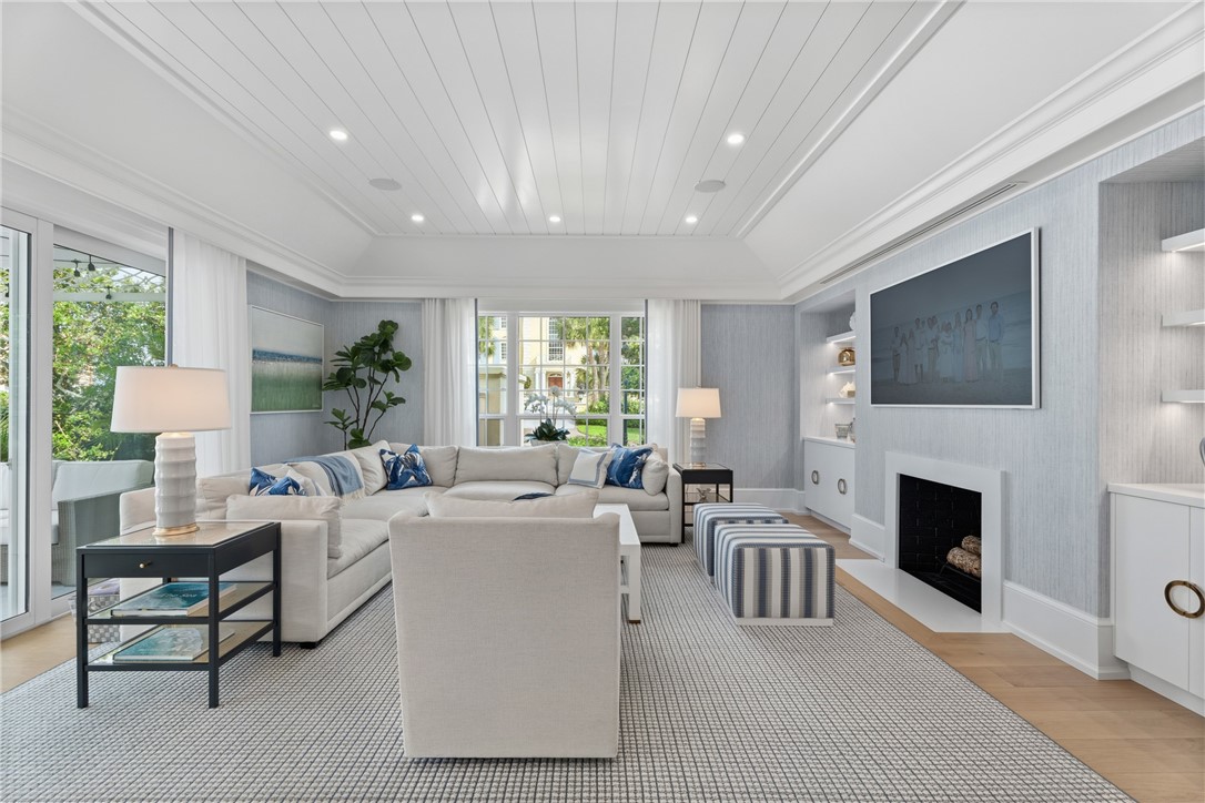 1070 Beach Road, Unit 1070 Vero Beach, FL 32963 - Photo 9 of 36 a living room with furniture a fireplace and a flat screen tv
