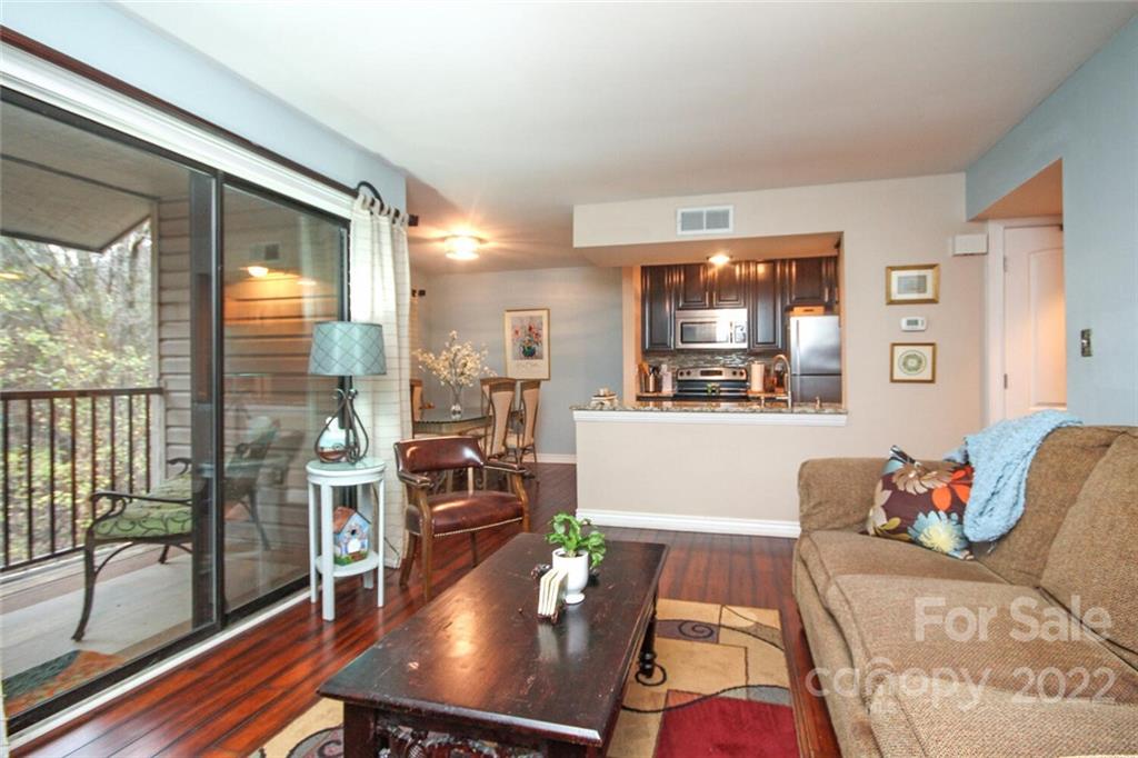 a living room with furniture and a floor to ceiling window