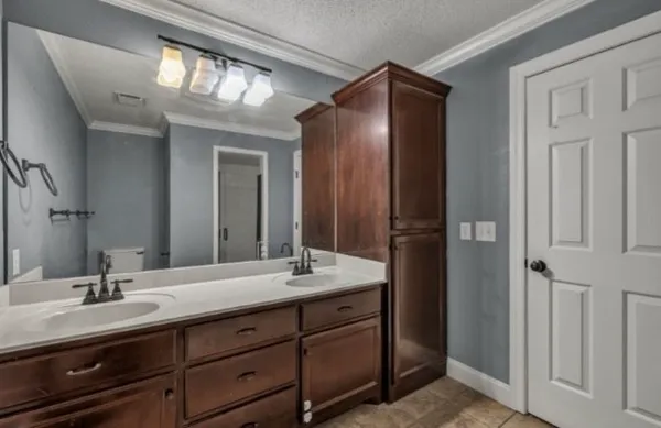 a bathroom with a double vanity sink and a mirror