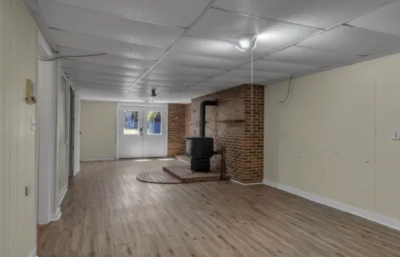 a living room with furniture a flat screen tv and kitchen view