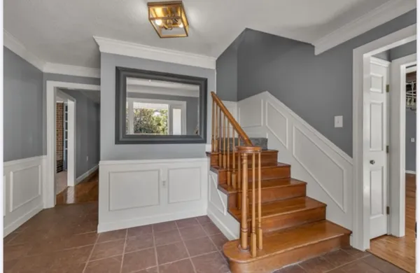 a view of an entryway with wooden floor and a living room