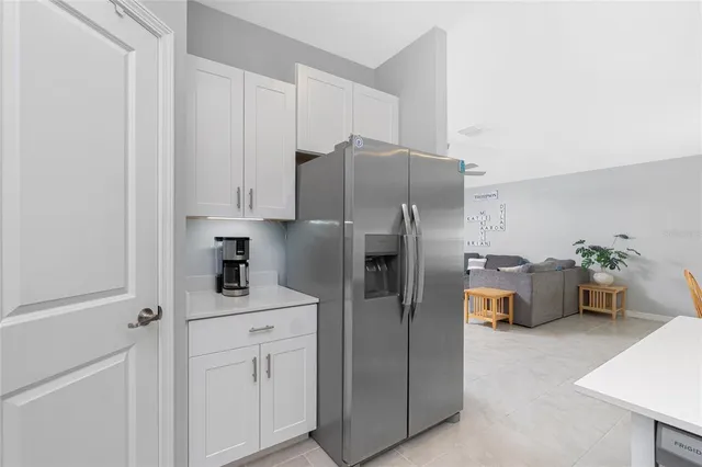 a kitchen with cabinets and a refrigerator