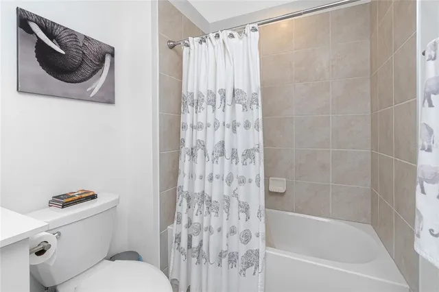 a bathroom with a toilet and a bathtub