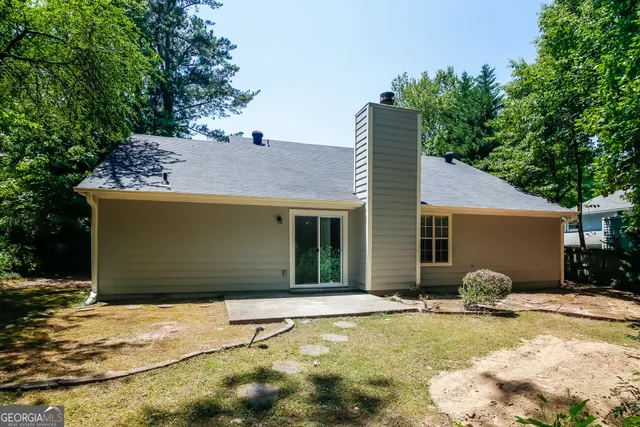 a backyard of house with yard and outdoor seating