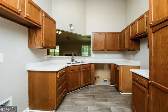 a kitchen with stainless steel appliances granite countertop a sink stove and cabinets