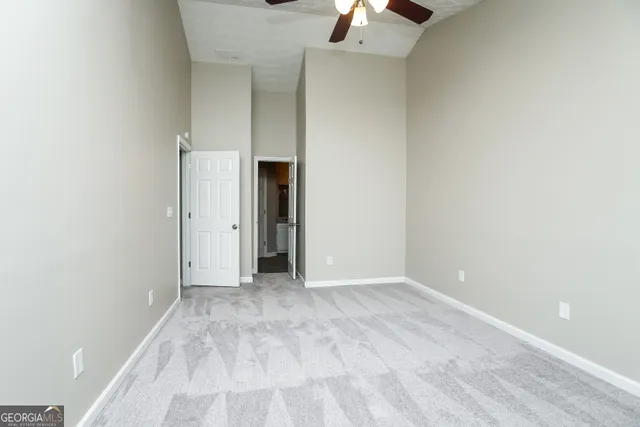 an empty room with a empty space and a ceiling fan