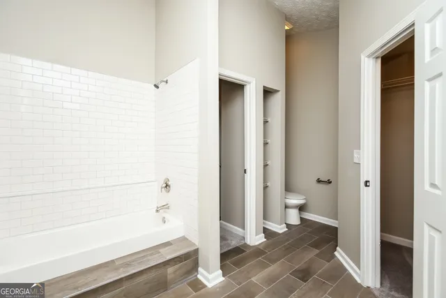 a bathroom with a bathtub and a shower