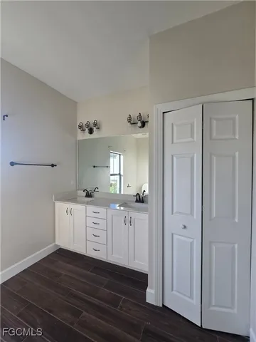 a kitchen with granite countertop cabinets and wooden floor