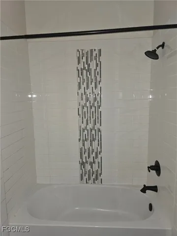 a bathroom with a bathtub and shower