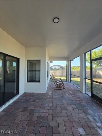 a view of an empty room with large windows