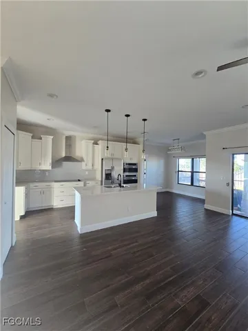 a view of a kitchen with cabinets and wooden floor