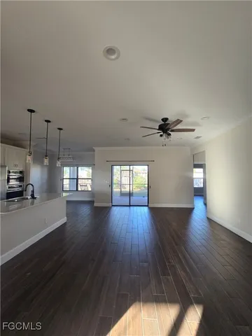 a view of a room with wooden floor