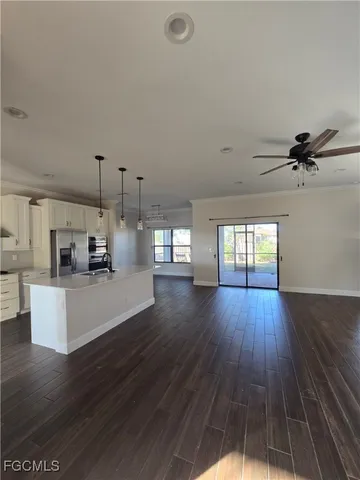 a view of a kitchen with cabinets and wooden floor