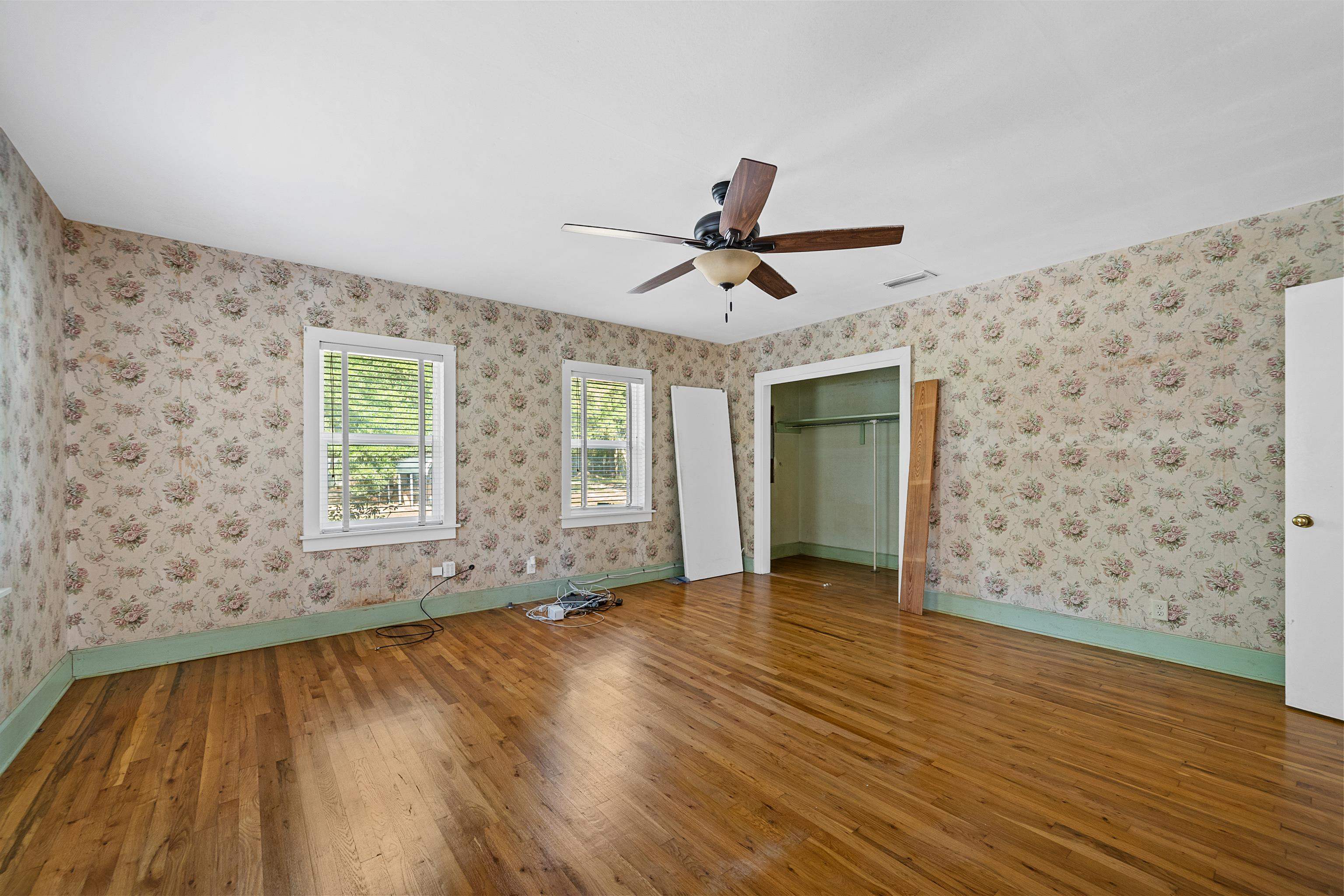 9350 Tompkins Road Stockton, AL 36579 - Photo 19 of 36 Unfurnished bedroom featuring hardwood / wood-style flooring, a closet, and a ceiling fan