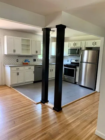 a kitchen with stainless steel appliances granite countertop a refrigerator a sink and a stove